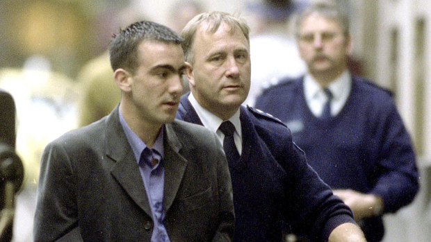 Jason Roberts, flanked by a prison guard, pictured coming into court in 2002.