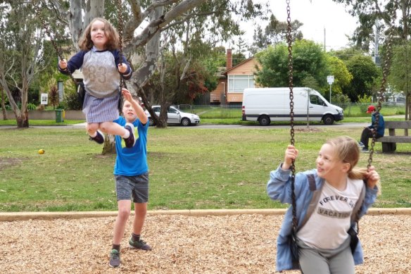 Sioban Ralph takes a swing at Ivanhoe Park, with her cousin Wes Reilly, pushing her, and Wes’ sister, Alice Reilly on the right.