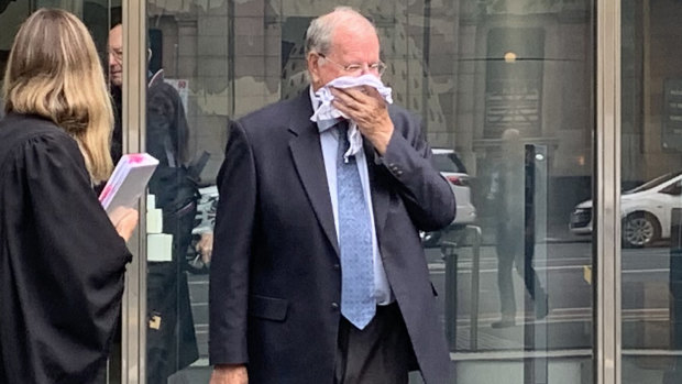 Christian Brother Rex Francis Elmer tried to hide his face after pleading guilty in the County Court in Melbourne on Monday.