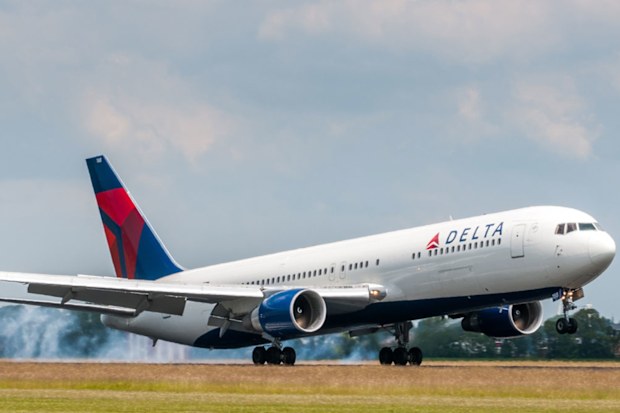 a Delta Airlines plane lands on the runway