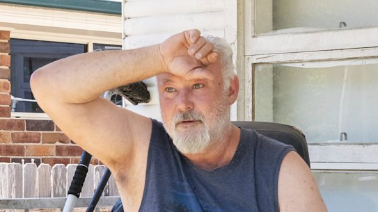 Keith Greenbank swelters outside his house in Penrith in 40-degree heat on Friday.