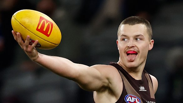 Hawthorn’s Jack Ginnivan shows the ball to an opponent.