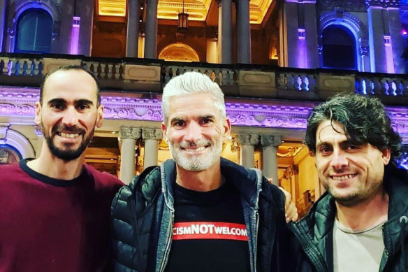 Refugee campaigner Craig Foster, centre, with Mostafa Moz’ Azimitabar, left, and  Farhad Bandesh, who were long held in captivity but are now free.
