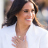 Meghan loves to play against type, pictured here, mixing a piece of hand jewellery from Catbird with a Cartier watch from Princess Diana.