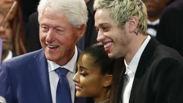 Former president Bill Clinton poses for a photo with singer Ariana Grande and her partner Pete Davidson during the funeral service.