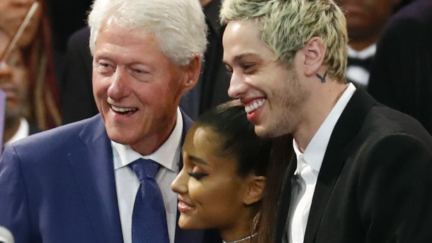 Former president Bill Clinton poses for a photo with singer Ariana Grande and her partner Pete Davidson during the funeral service.