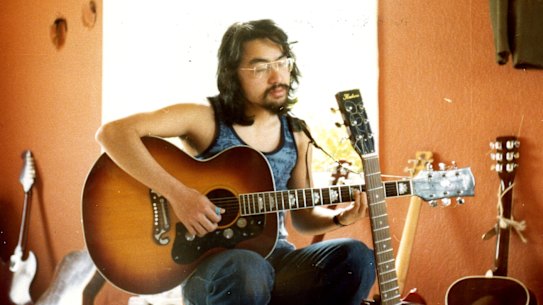 Kazuo Ishiguro playing guitar in the British summer of 1977 in Broad Oak, Kent. 