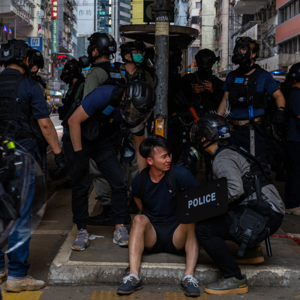 A pro-democracy supporter is detained by police during an anti-government rally on May 24 in Hong Kong.