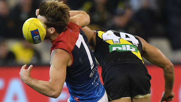 Stack's on: Melbourne skipper Jack Viney is crunched by Richmond's Sydney Stack last Wednesday.