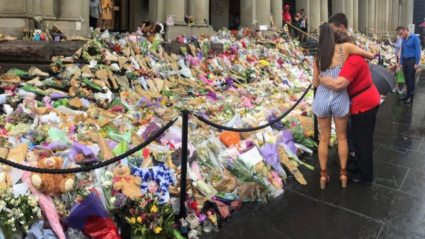 People leave tributes after a car mowed down pedestrians on Bourke Street in January 2017.