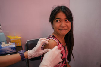 A young girl from Tondo, Manila, is seen in a Likhaan clinic for her free HPV vaccination.