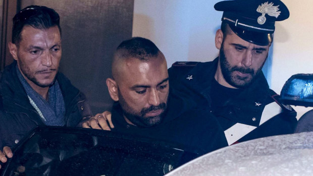 Ostia crime figure Roberto Spada, middle, after his arrest in January.  