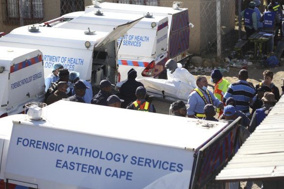 A body is removed from a nightclub in East London, South Africa.