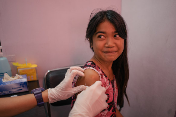 A young girl from Tondo, Manila, is seen in a Likhaan clinic for her free HPV vaccination.