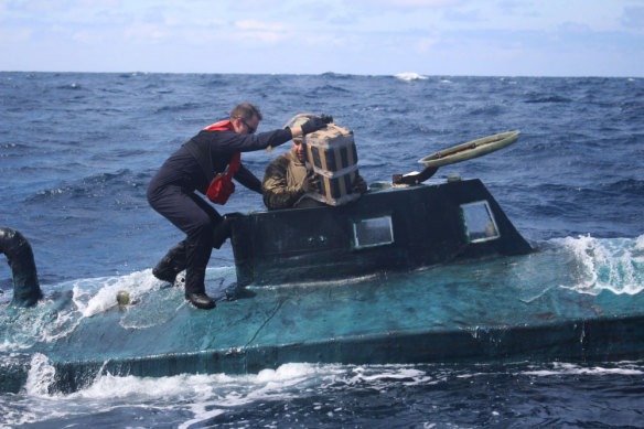 US Coast Guard members board a self-propelled semi-submersible in international waters.