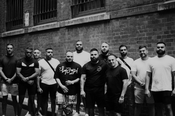 Far left is Stephen Bou-Abbse, second left is Joseph Vokai. Rapper Ay Huncho (real name Ali Younes) is fifth from left, holding a bag. The tall man in the white T-shirt behind him is Masood Zakaria. Immediately to the right of Ay Huncho is John Ray Bayssari, who has his arm around Andy Nahas.