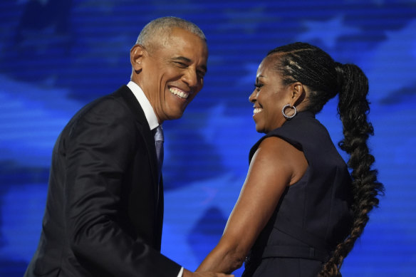 Former US president Barack Obama with former first lady Michelle Obama as he is introduced during the Democratic National Convention in Chicago. 