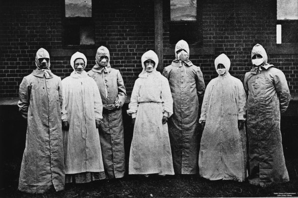 Dr Burnett Ham and his medical and nursing staff photographed during an earlier outbreak in Brisbane.