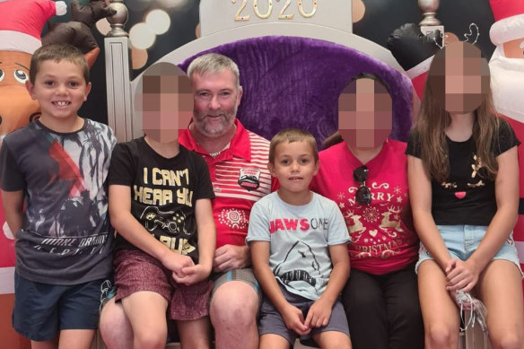 Father Joseph Shorey (seated) with Sheldon (right) and Shane (far left). Both boys died in a hit and run accident in Wellington, NSW in January.