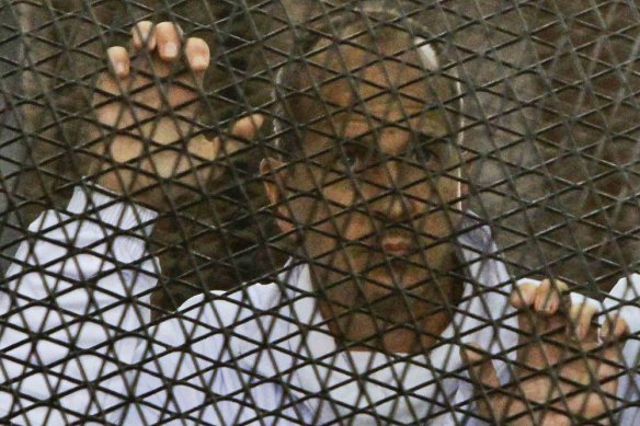 Peter Greste inside a defendants’ cage in an Egypt courtroom during his trial in 2014.