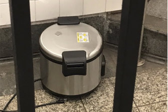 This photo provided by NYPD shows a suspicious object which looks like a pressure cooker or electric crockpot on the floor of the New York City Subway on Friday.