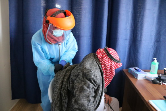 A medic helps a patient in the Doctors Without Borders clinic in Hebron. 