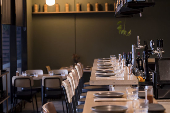 The best seats at Kura have a view of the grill.