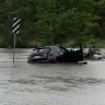 Flooding cuts roads, swamps cars as torrential rain tops up dams
