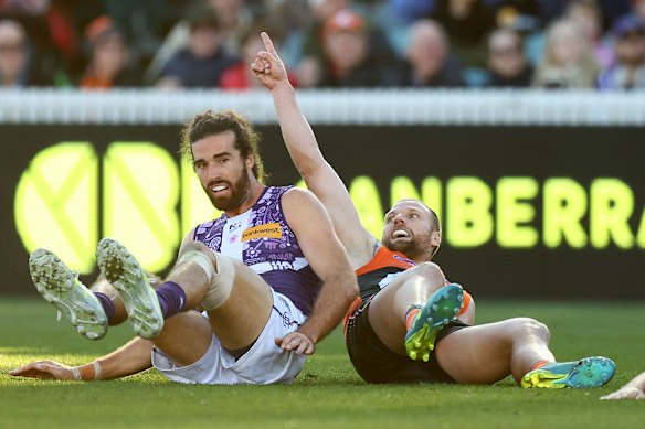 Jake Stringer of celebrates scoring a goal as Fremantle captain Alex Pearce looks on in round 17. The victory to the Giants brought an end to the Fremantle winning streak of 14 games.