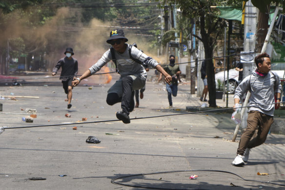 Anti-coup protesters run to avoid military forces during a demonstration in Yangon, Myanmar, on Wednesday. 