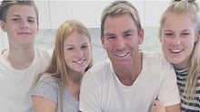 Warne with his three children.