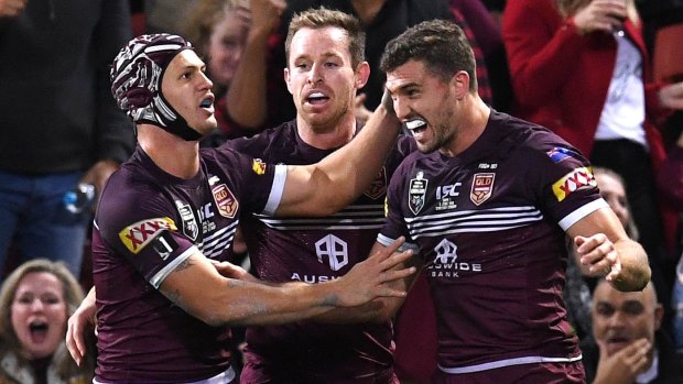 No.1 with a bullet: Queensland fullback Kalyn Ponga congratulates Corey Oates after setting up his try with a bullet pass.