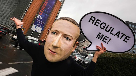 A campaigner from the global citizens movement Avaaz wearing a mask of Facebook CEO Mark Zuckerberg.