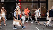 Pedestrians walk past an NAB office.