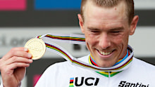 Australia's Rohan Dennis poses with his gold medal on the podium after winning the men's elite individual time trial event