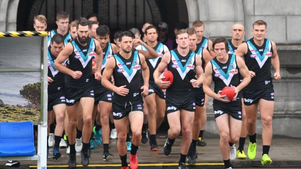 Port Adelaide  enter the field for a game in Shanghai.