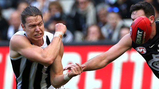 Tom Langdon handballs clear.