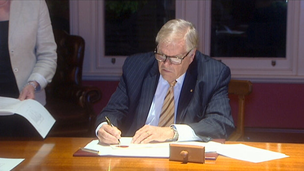 WA Governor Kim Beazley signing the legislation into law.