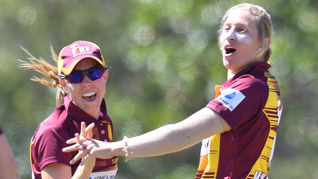 Back in the thick of it: Delissa Kimmince (right) celebrates a wicket with Queensland Fire.