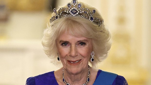 Queen Camilla grabs the tiara while waiting for the crown