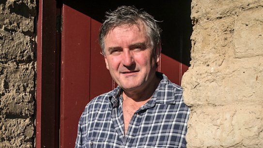 Richard Glover at the door of his mud brick house he built over many decades.