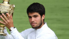 Carlos Alcaraz lifts the Wimbledon trophy.