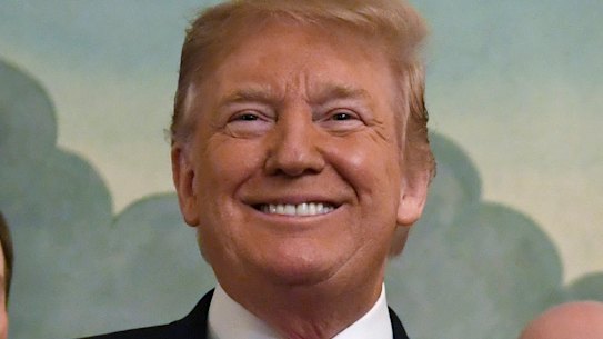 Donald Trump smiles as he holds a proclamation formally recognizing Israel's sovereignty over the Golan Heights with Israeli Prime Minister Benjamin Netanyahu.