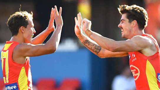 Rising Suns: Alex Sexton (right) and Will Powell celebrate a goal against the Dockers.