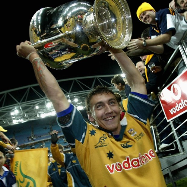 Mat Rogers holds the Bledisloe Cup aloft in 2002.
