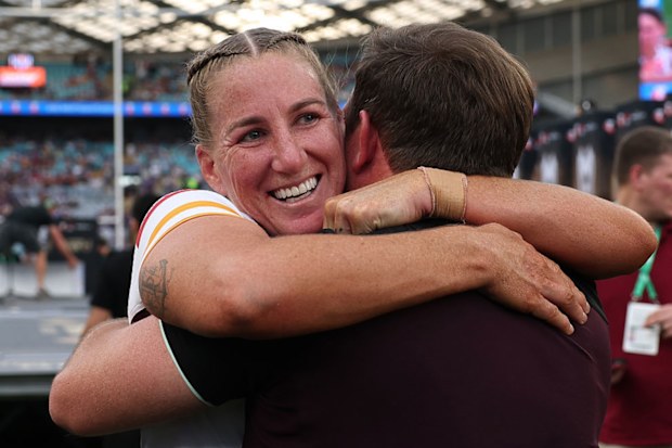 Ali Brigginshaw embraces a member of the Broncos staff.