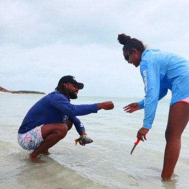 Mills with his niece, Miia, cleaning fish at Thursday Island.