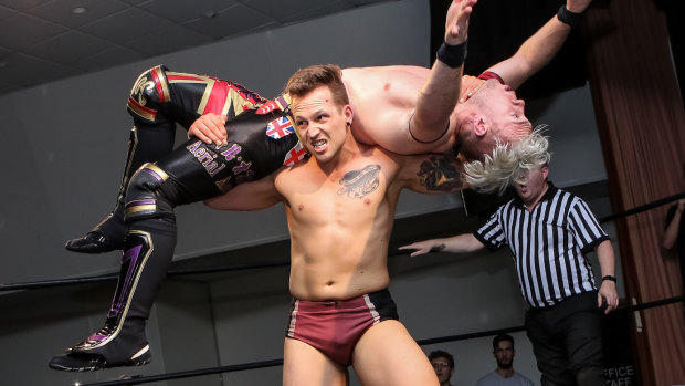 Living the dream: Robbie Eagles carries English wrestler Will Ospreay.
