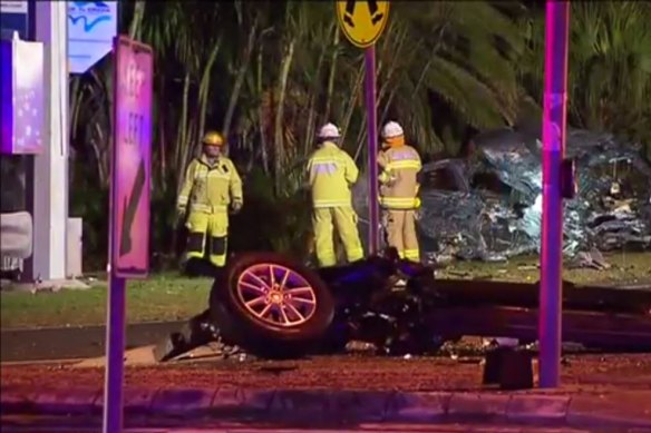 The car hit traffic lights, the force causing the vehicle to split into pieces. 