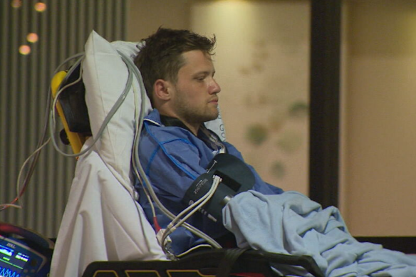 Cameron Clark is transported to hospital under police guard, after allegedly attempting to kill a waitress at Easts Leagues Club.